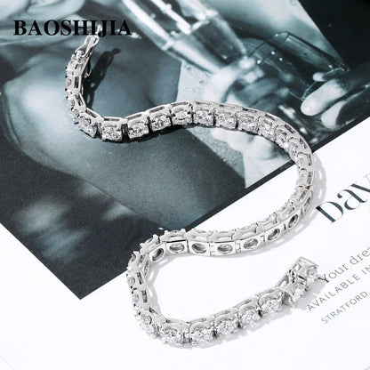 Silver bracelet with clear stones on a magazine background, featuring the brand 'BAOSHIJIA'.