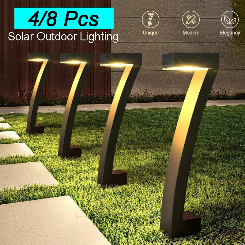 Solar outdoor lighting fixtures on grass with pathway in front