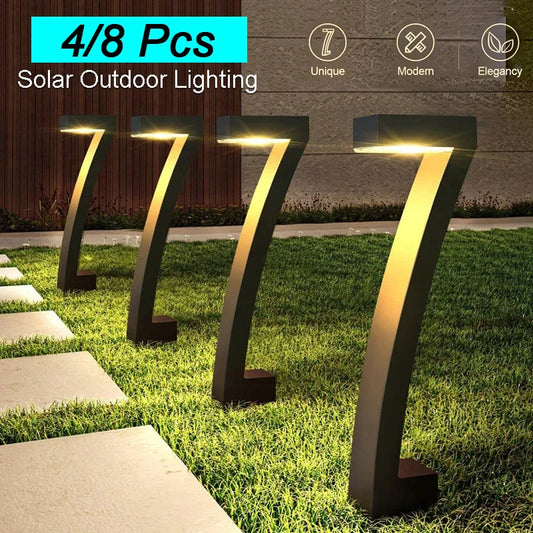 Solar outdoor lighting fixtures on grass with pathway in front