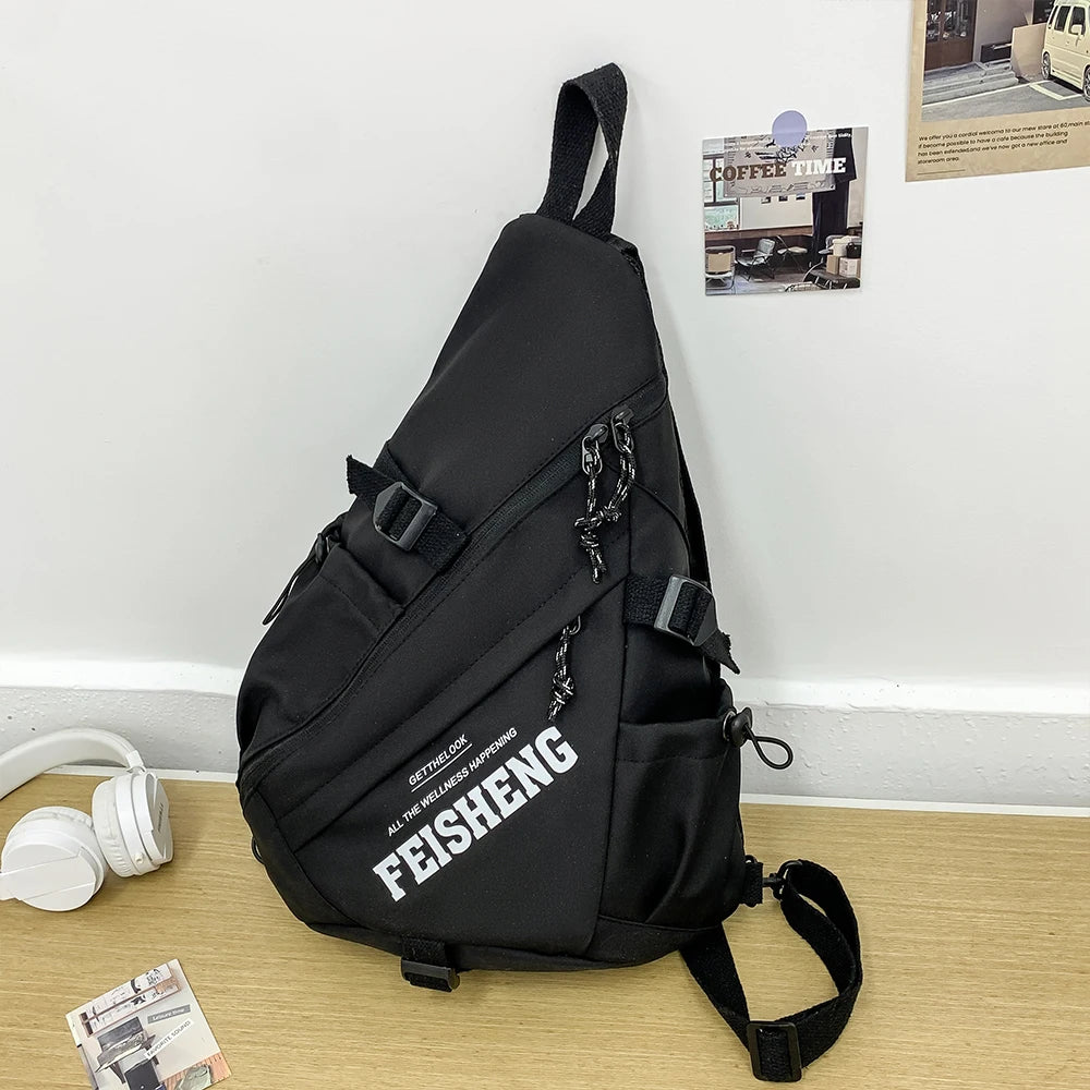 Black sling bag with 'FEISHENG' branding on a wooden surface.