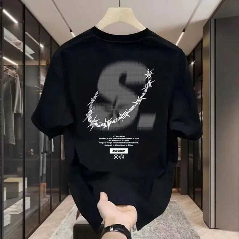 Black t-shirt with a white graphic design on a hanger in a store.