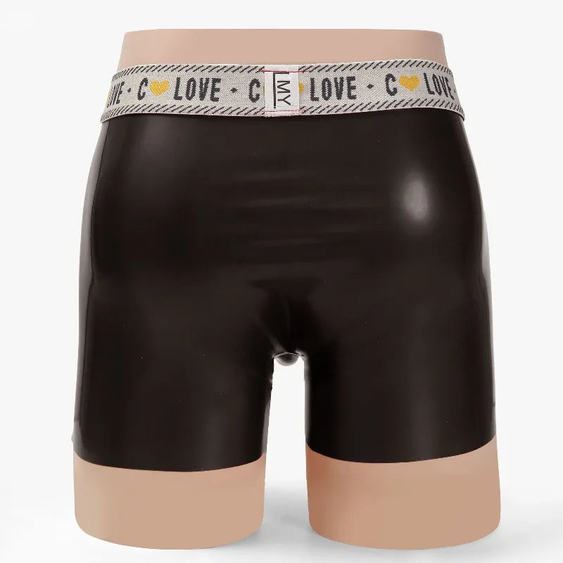 Black rubber shorts with a patterned waistband on a mannequin against a white background