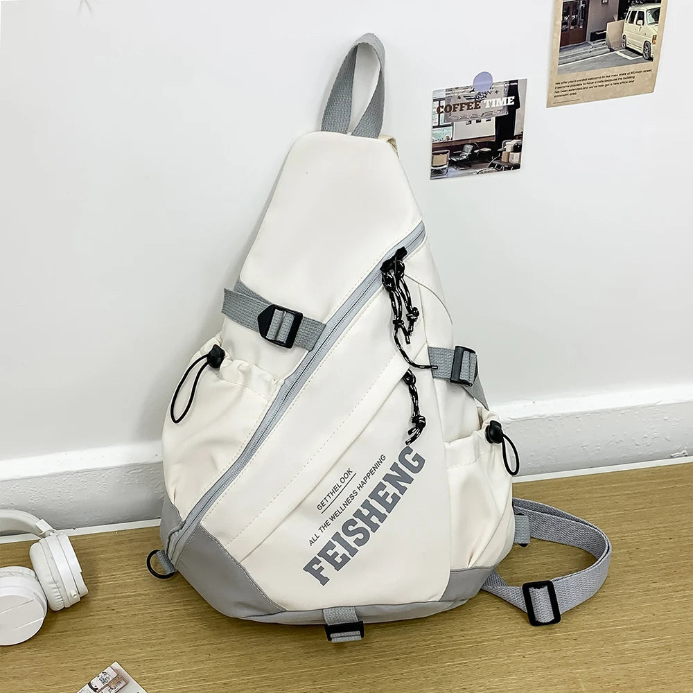 White and gray sling bag with 'FEISHENG' branding on a wooden surface.