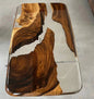 Wooden table with a clear resin overlay on a gray surface