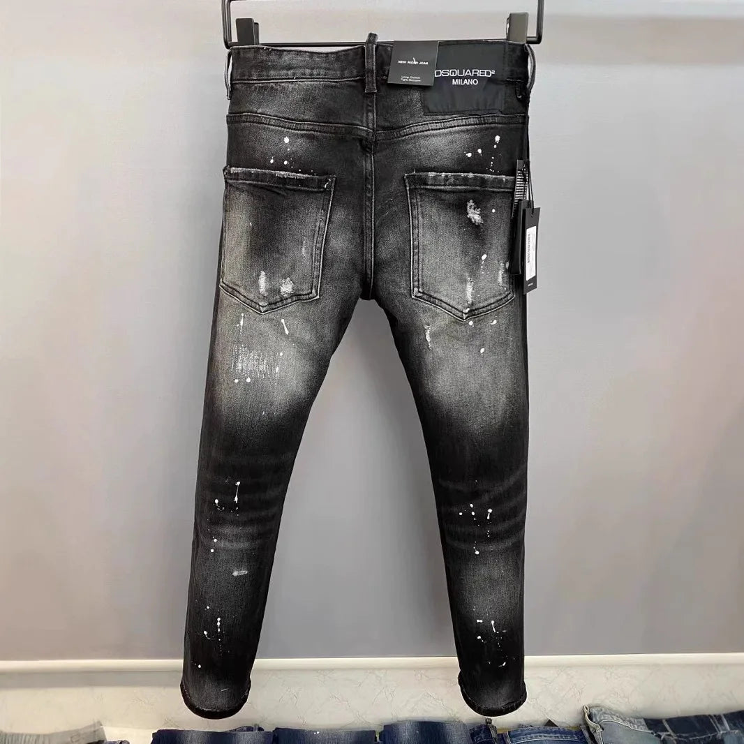 Black distressed jeans with a brand tag on a gray background