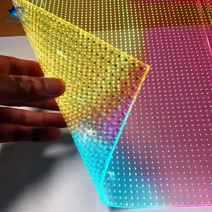 Colorful LED panel with a hand holding a triangular piece of the material.