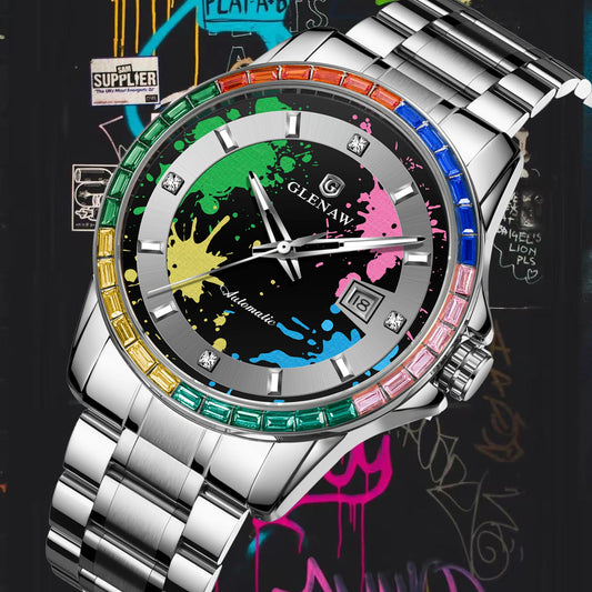 A silver stainless steel wrist watch with a colorful paint-splatter dial and a rainbow-colored bezel, shown against a graffiti-patterned background.