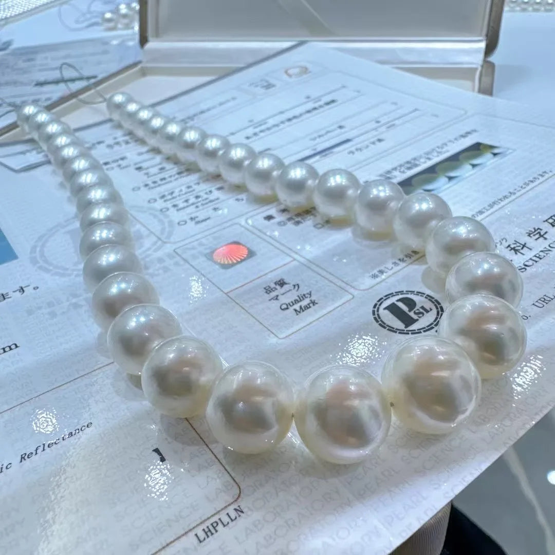 Pearl necklace on a newspaper with visible brand logo