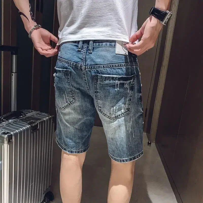 Person wearing blue denim shorts with a suitcase in the background
