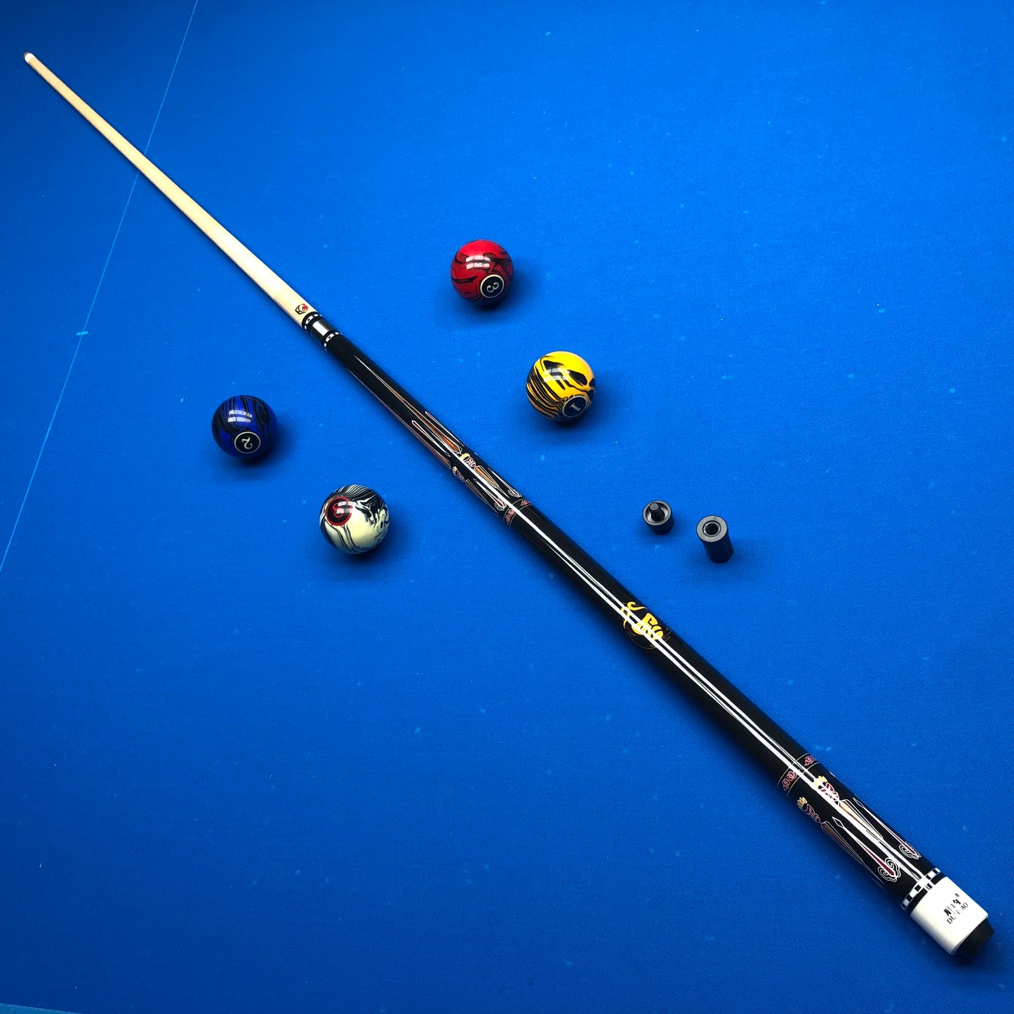 Pool cue with pool balls on a blue surface