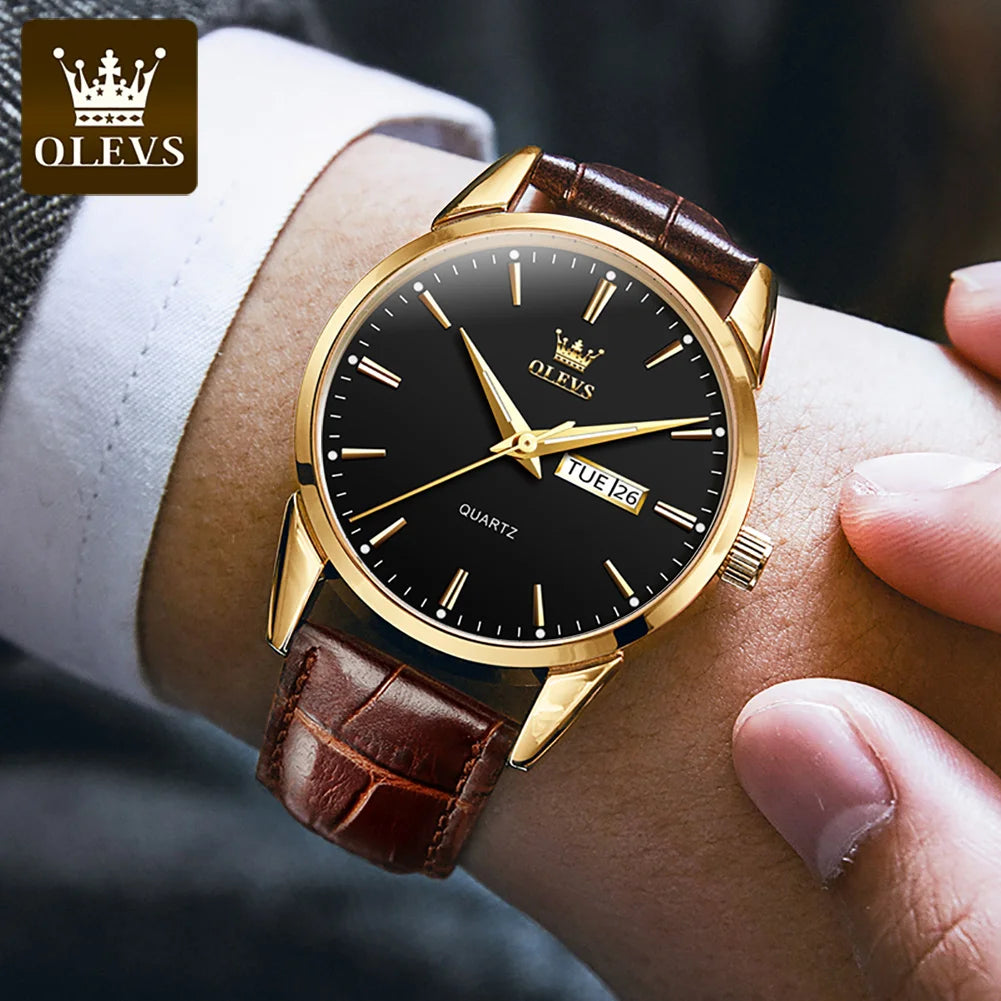 Gold watch with black face and brown leather strap worn on a wrist, brand 'OLEVS' visible.