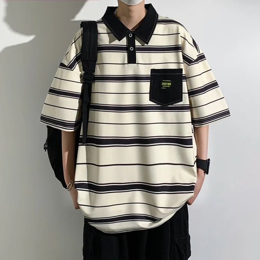 Person wearing a striped polo shirt with a black backpack against a plain background