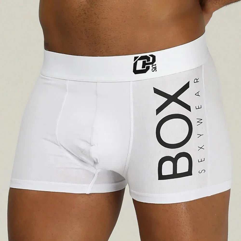 White boxer briefs with 'BOX' and 'SEXYWEAR' text on a beige background