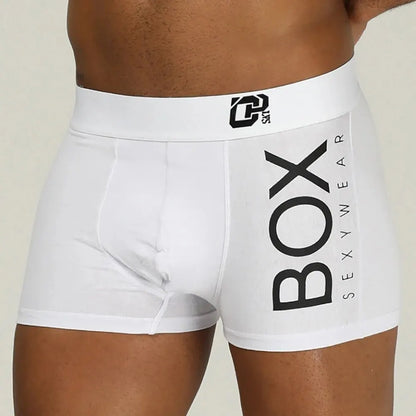 White boxer briefs with 'BOX' and 'SEXYWEAR' text on a beige background