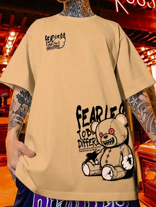 Beige t-shirt with graphic design and text worn by a person with tattoos.