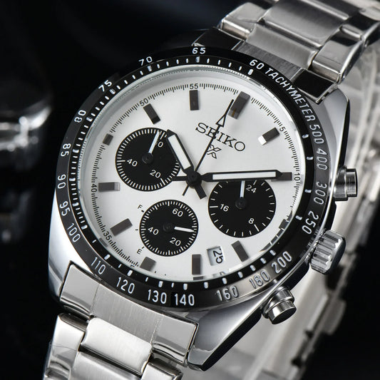 Seiko watch with silver metal strap on a dark background