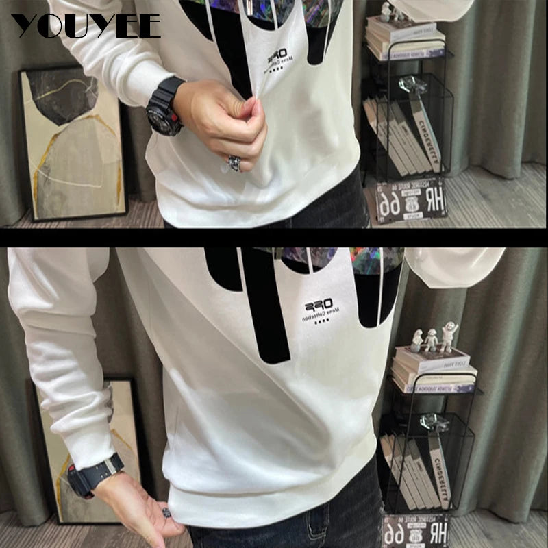 White long-sleeve shirt with black accents worn by a person indoors.