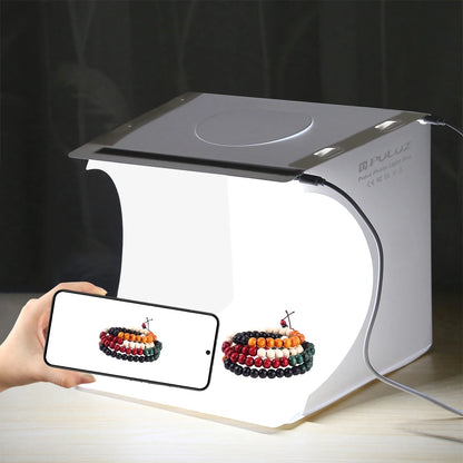 Small photo studio lightbox with colorful bracelets on a dark background
