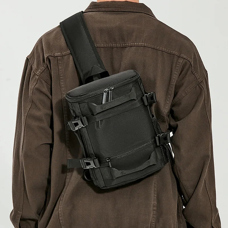 Person wearing a black sling bag over a brown jacket on a white background