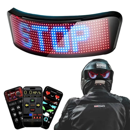 LED sign displaying 'STOP' with a person wearing a helmet and jacket in the background