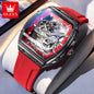 Luxury watch with red strap and visible brand logo on a light background