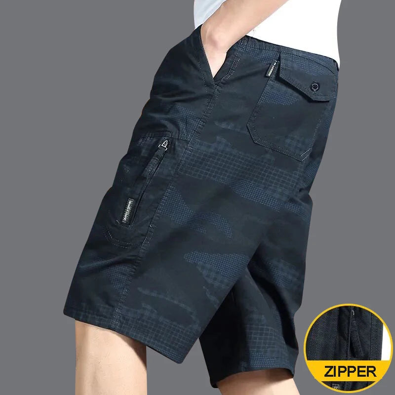Dark blue cargo shorts with zippers on a gray background