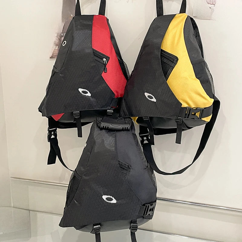 Three backpacks in black, red, and yellow on a white background