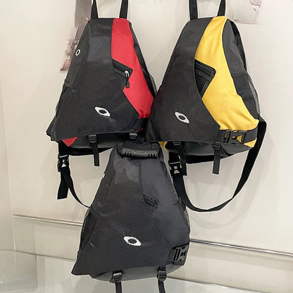 Three backpacks in black, red, and yellow on a white background