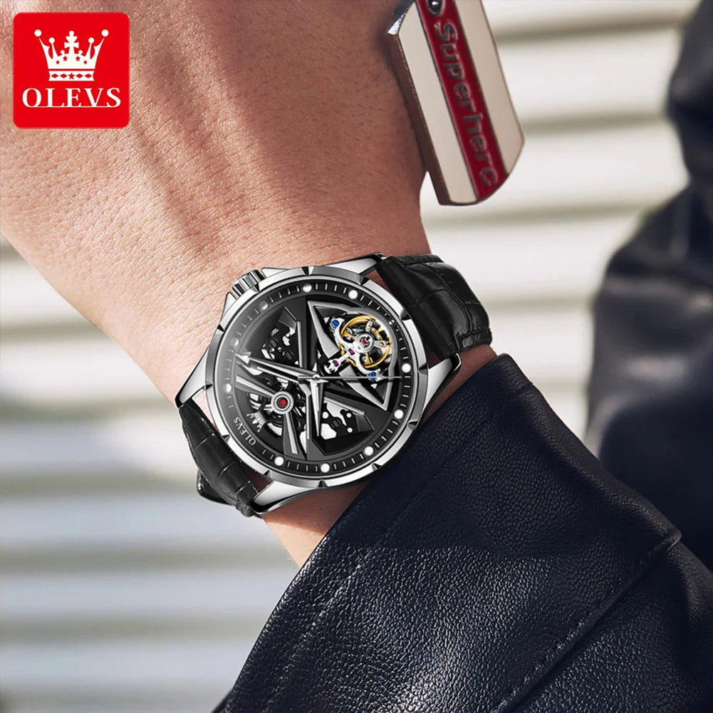 Close-up of a person wearing a black and silver watch with a blurred background
