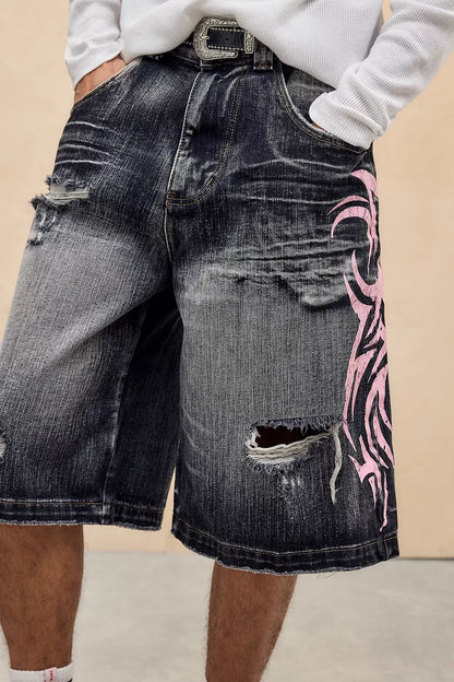 Denim shorts with pink tribal design on a beige background