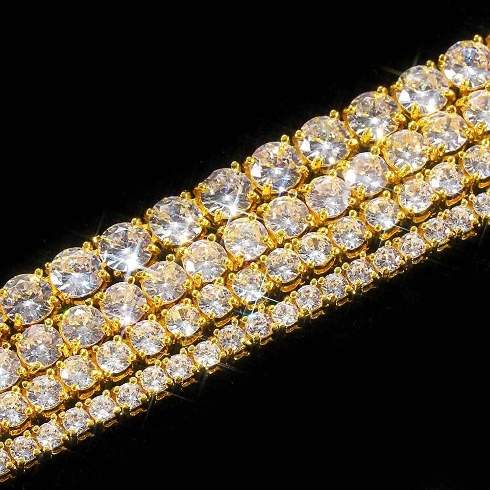 Gold bracelet with clear gemstones on a black background