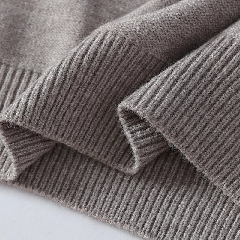 Close-up of a folded gray sweater on a white background