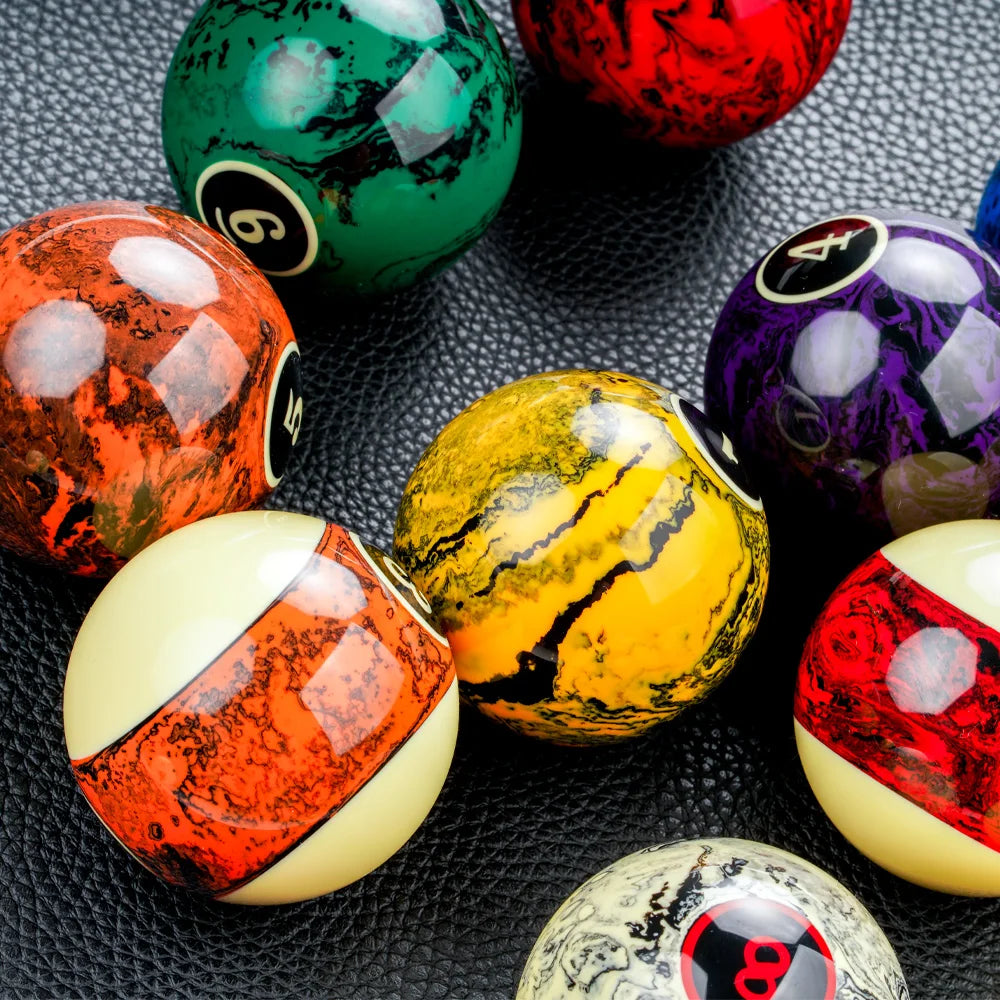 Colorful marbled billiard balls on a textured surface