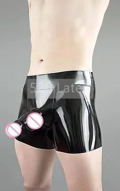 Black latex shorts with pink lights worn by a person on a gray background