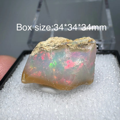 Opal stone on a white cushion with a clear box in the background