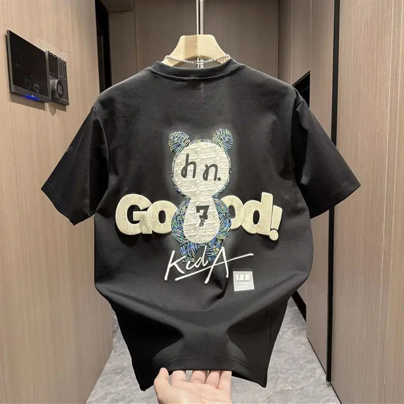 Black t-shirt with graphic design and text on a wooden door background