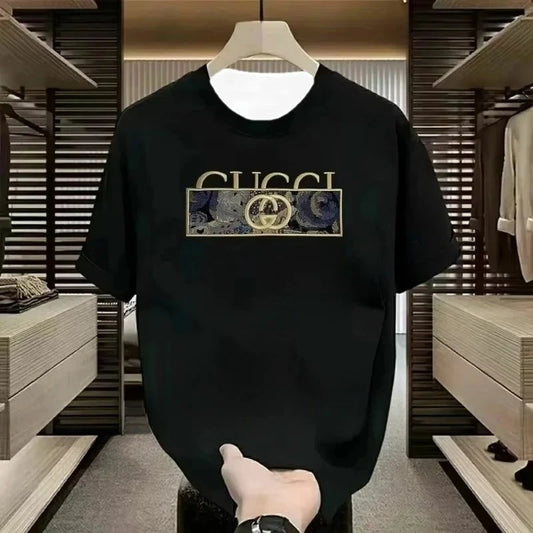 Black Gucci t-shirt with gold logo on a hanger in a store setting