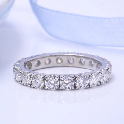 Silver ring with diamonds on a light blue background