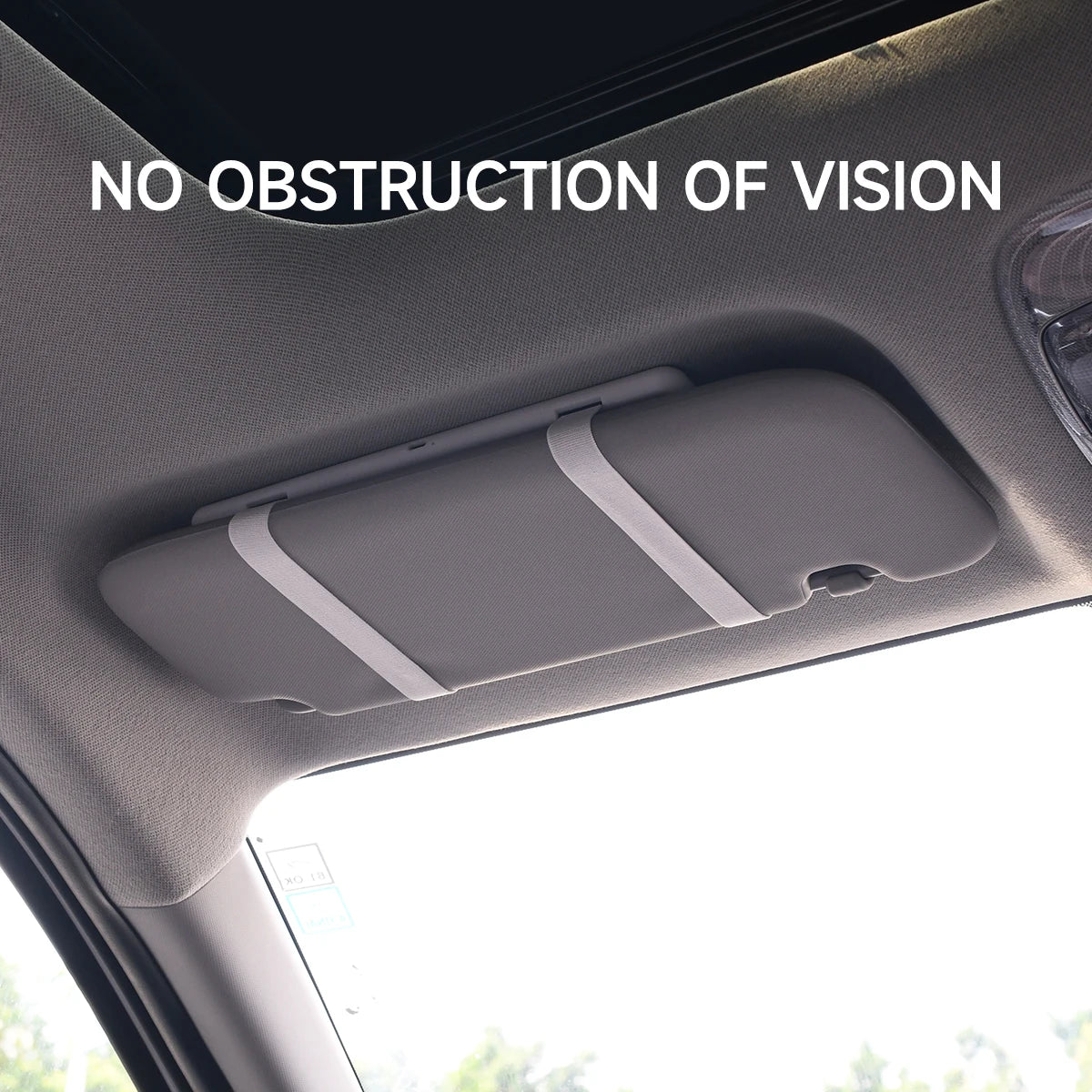 Car sun visor with 'No Obstruction of Vision' text