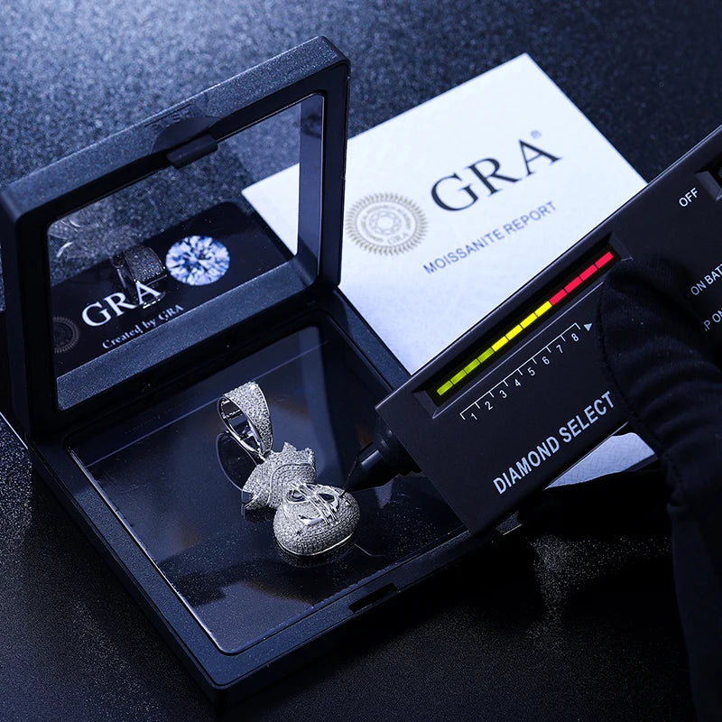 Diamond appraisal tool with 'GRA' branding and a diamond ring on a dark surface
