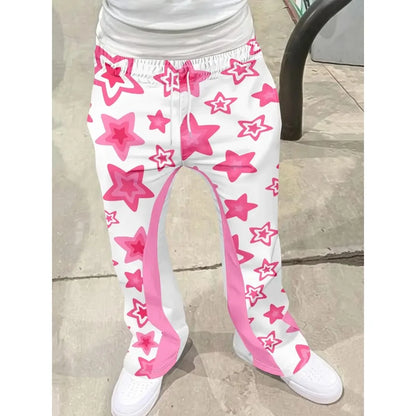 White pants with pink star patterns worn by a person on a tiled floor.