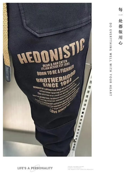 Navy blue pants with 'HEDONISTIC' text and branding on a blurred background