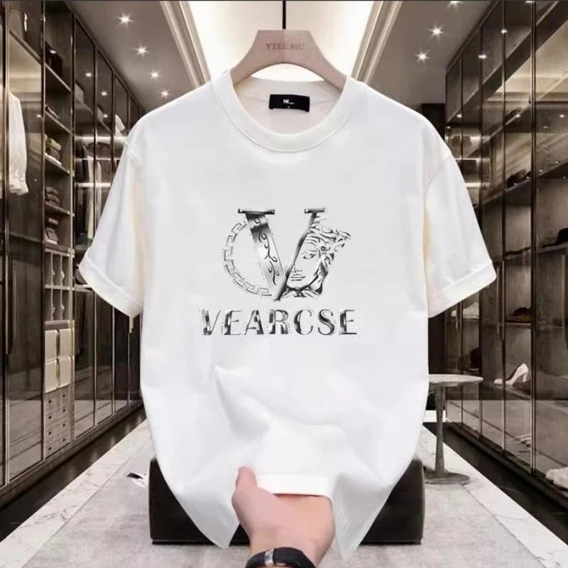 White t-shirt with black logo and text held in a high-end store.