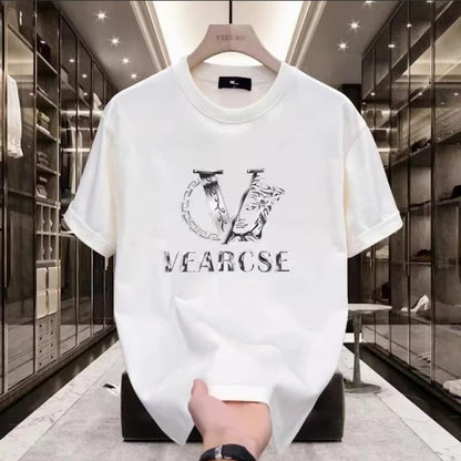 White t-shirt with black logo and text held in a high-end store.