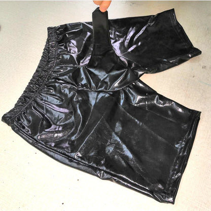 Black shiny pants on a light gray background