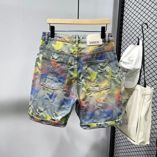 Colorful denim shorts on a hanger with a white background