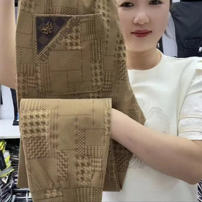 Person holding a brown textured fabric with a geometric pattern