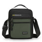 Green crossbody bag with black straps on a white background