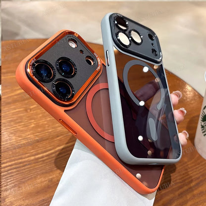 Two phone cases, one orange and one gray, held by a hand on a wooden surface.