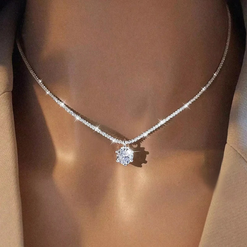 Diamond necklace on a person wearing a beige top